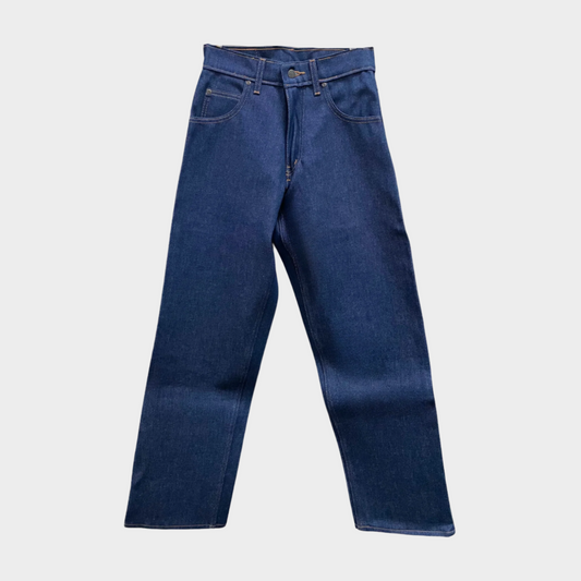 A pair of hanging blue work jeans with flat front, two front pockets and a coin pocket. Standard button and zipper closure and belt loops.