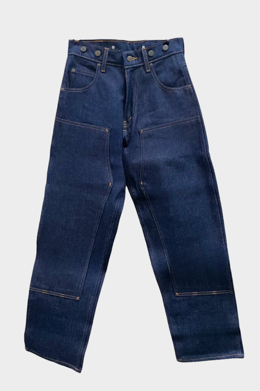 A pair of hanging blue work jeans with reinforced knee panels on front, two front pockets and a coin pocket. Standard button and zipper closure and belt loops. Includes suspender buttons.