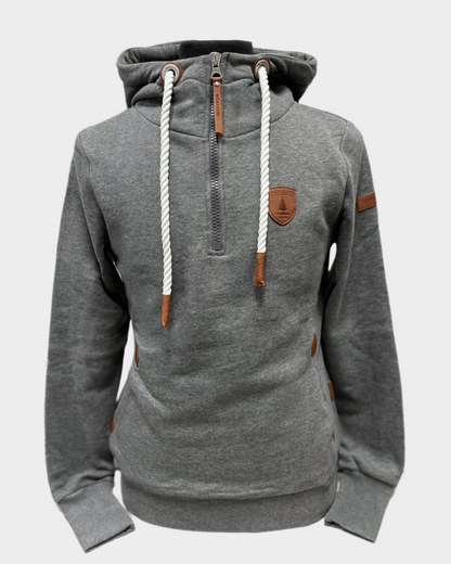 Womens pullover hoodie. Hood with white adjustable rope drawstrings and vegan leather caps. Half zipper. Side pockets. Brushed French terry interior. Wanakome patch logo embroidered on sleeve and chest. Has thumbholes on wrist cuff. Shown in dark heather gray