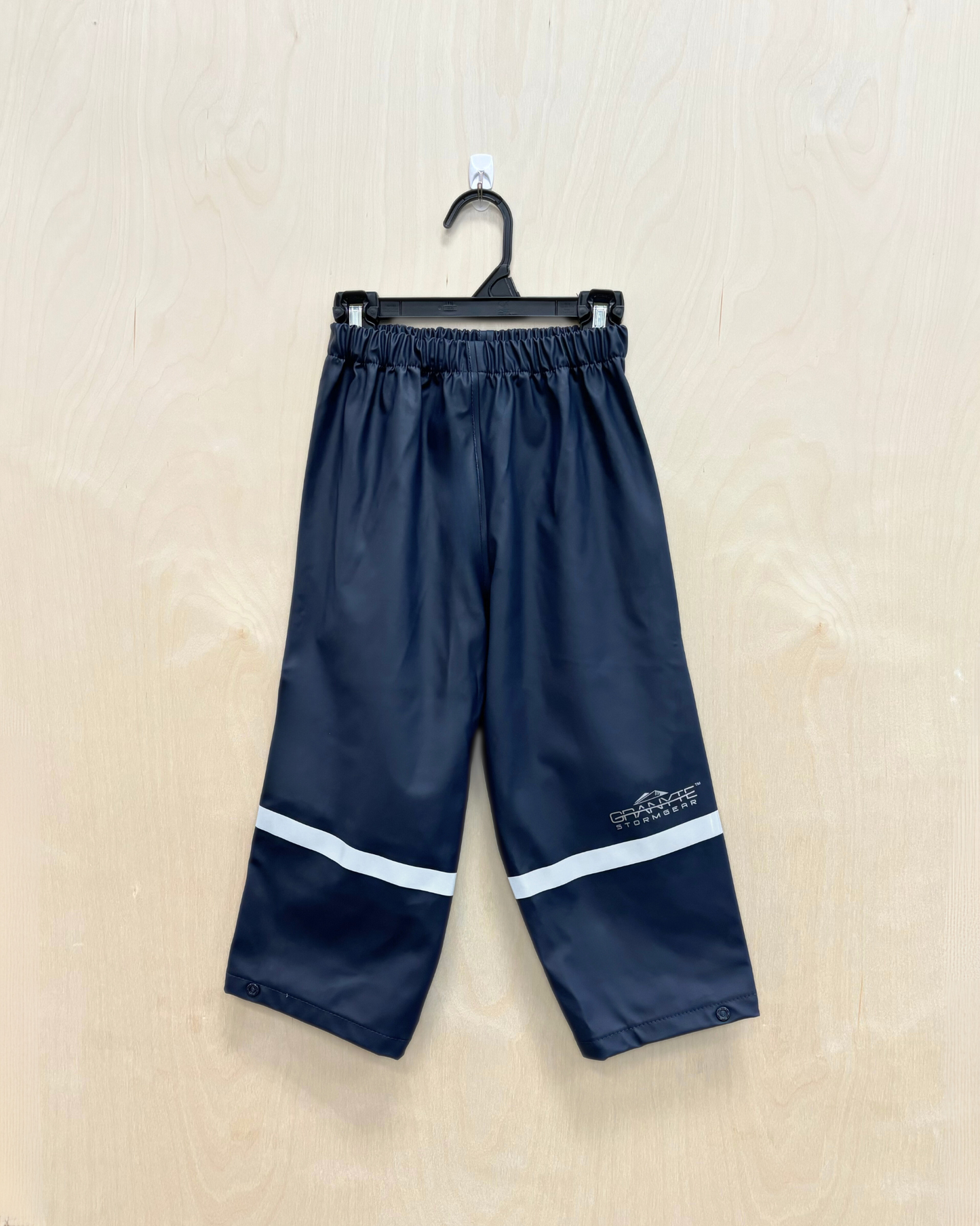 kids dark blue rain pants with reflective strip across ankles