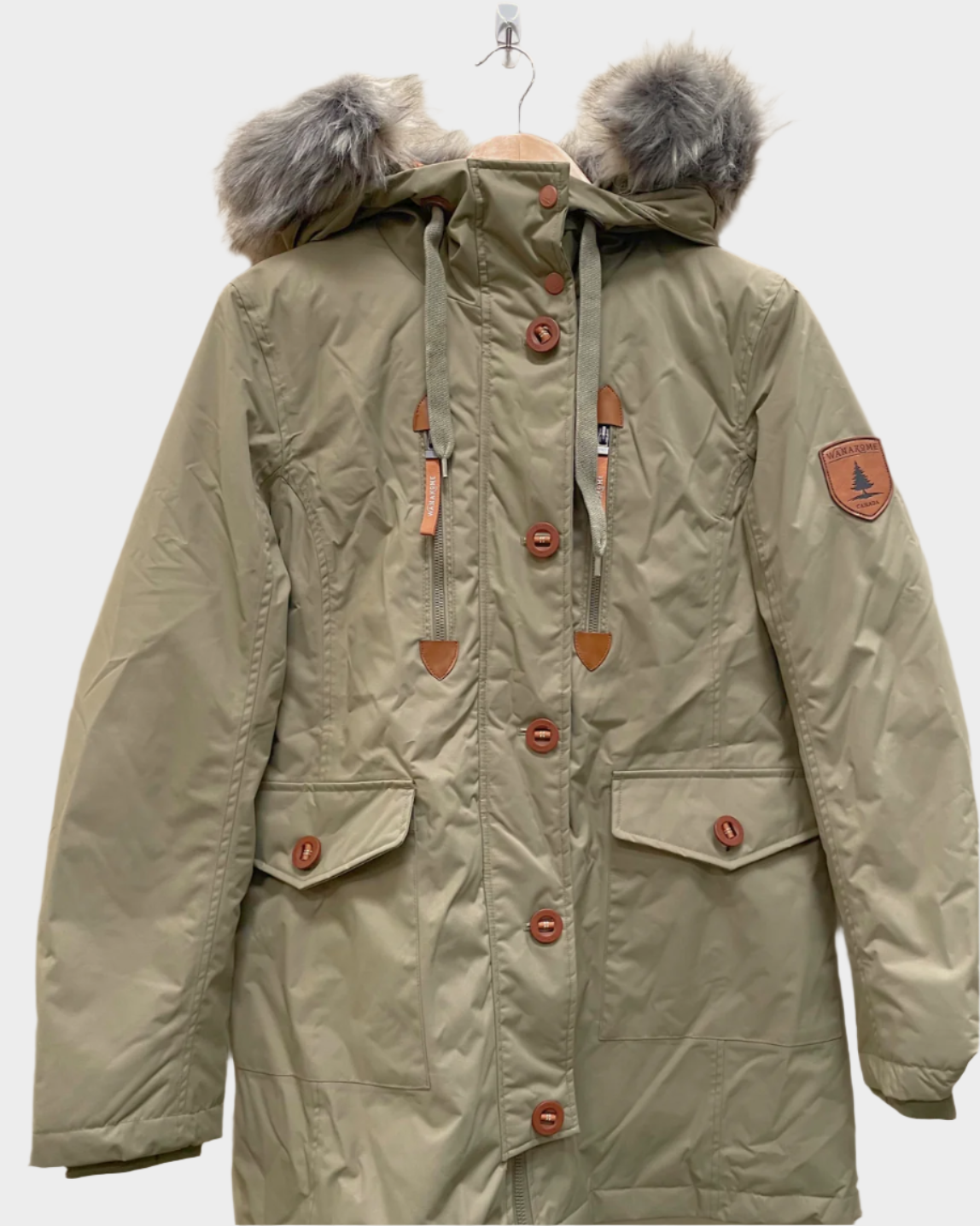 Womens parka with fur lining on the hood, drawstrings, a tailored fit with seams down the front. two large front pockets