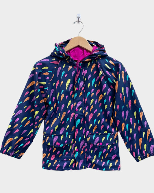 Kids lined rain coat with lining, attached hood, and pockets. Shown in colorful rain drops and dark purple background on coat. 