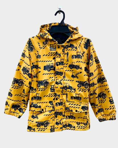 Kids lined rain coat with lining, attached hood, and pockets. Shown in construction pattern with a yellow background and excavator in silhouette. 