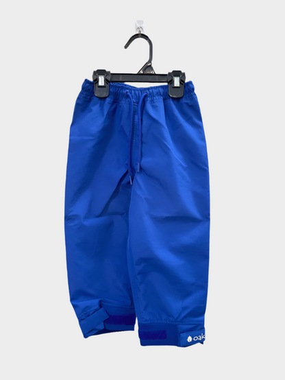 A pair of kids rain pants with an elastic waistband and drawstring. Ankles have a neoprene covered velcro adjustment. Shown in navy