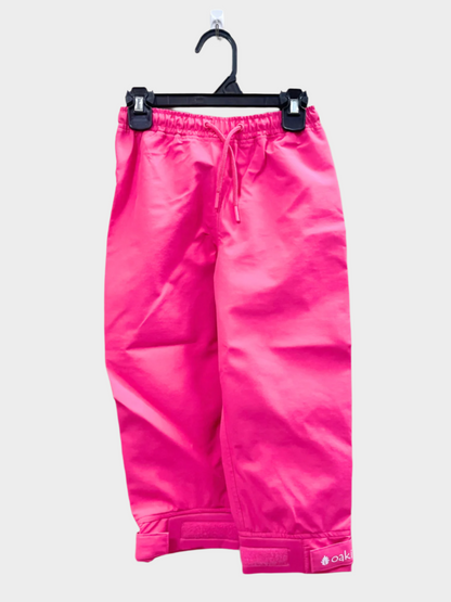 A pair of kids rain pants with an elastic waistband and drawstring. Ankles have a neoprene covered velcro adjustment. Shown in bright pink