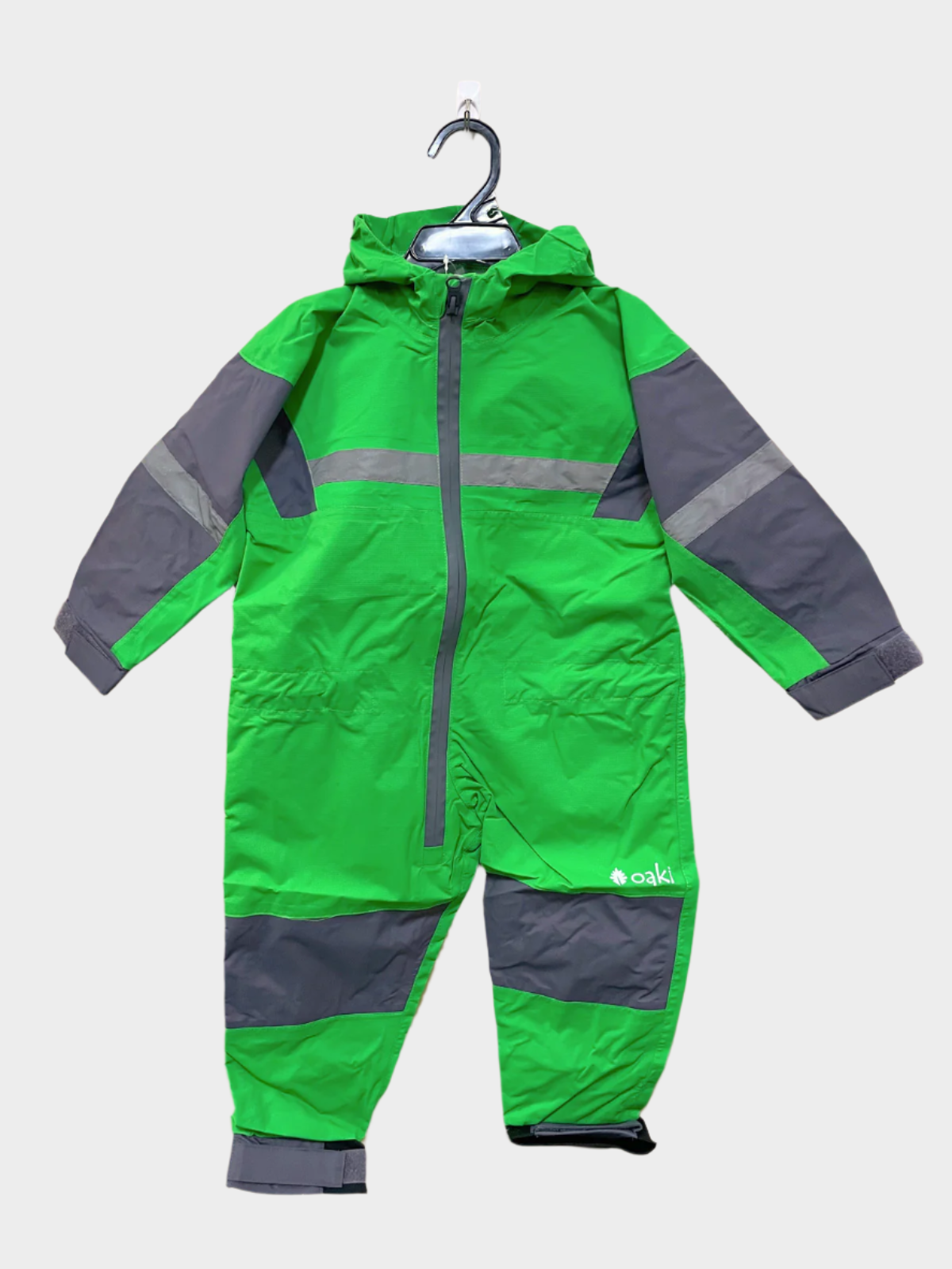 Kids rain suit with attached hood, grey color blocking on top of arms and across shins with safety reflective strips. Shown in a bright green. 