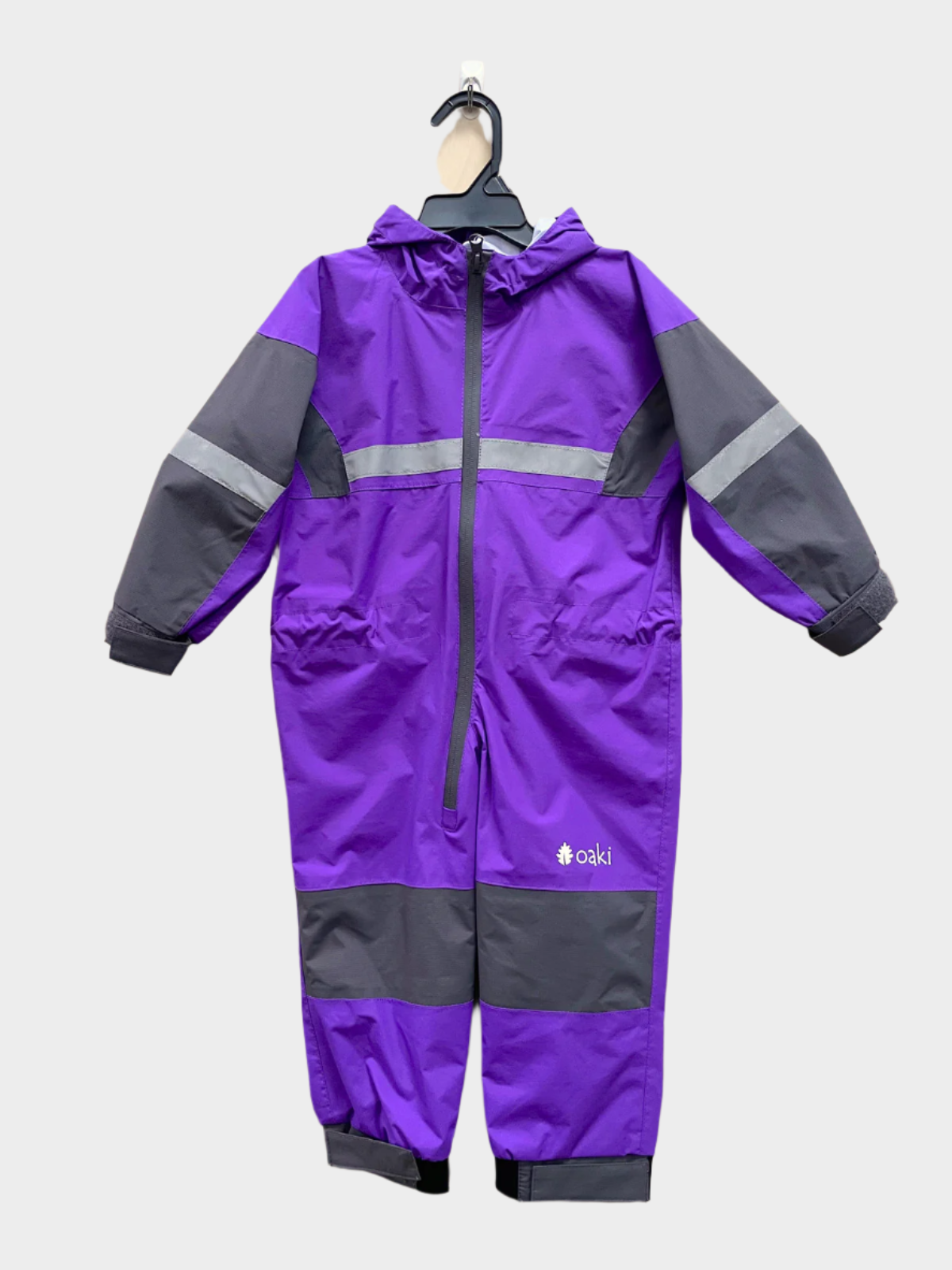 Kids rain suit with attached hood, grey color blocking on top of arms and across shins with safety reflective strips. Shown in purple.