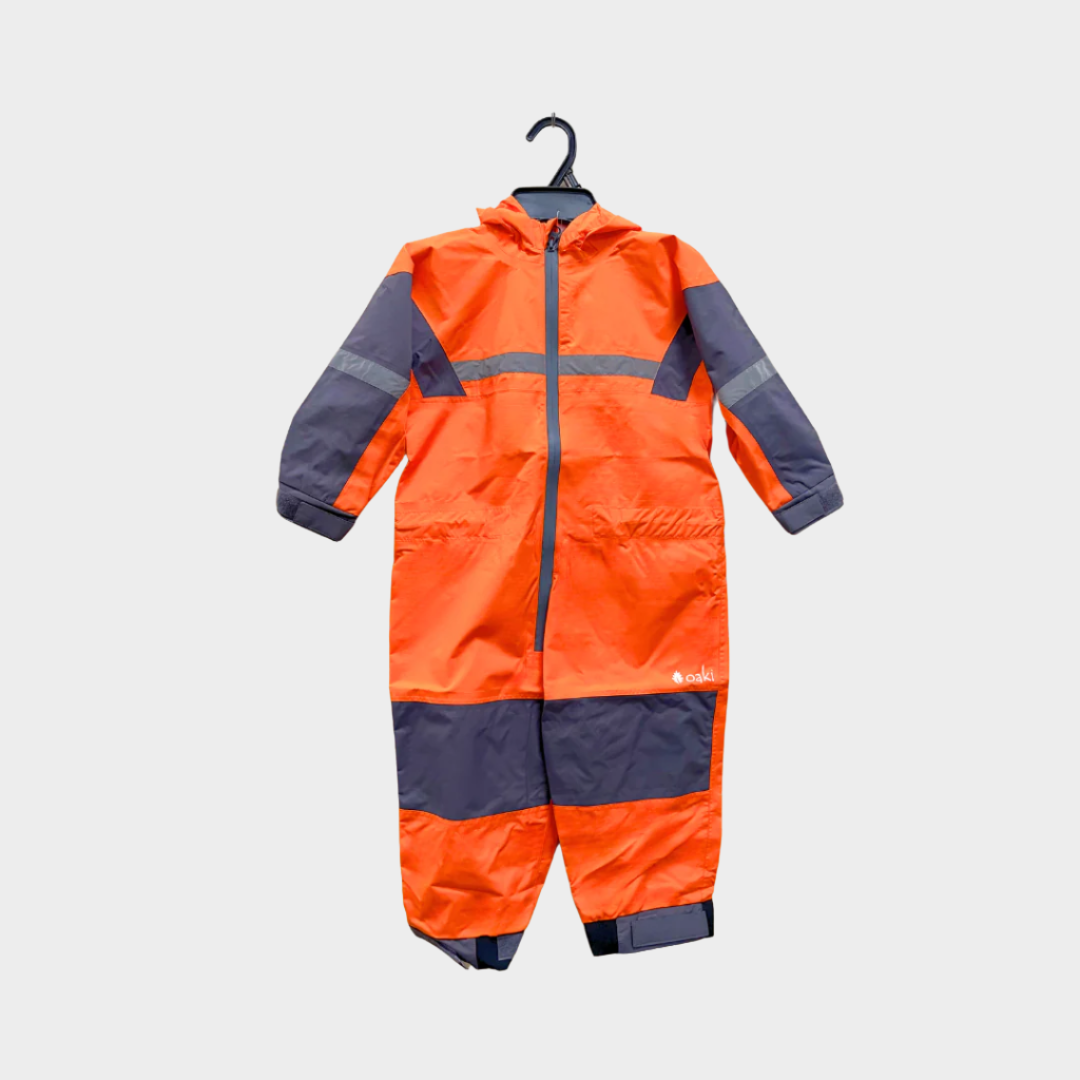 Kids rain suit with attached hood, grey color blocking on top of arms and across shins with safety reflective strips. Shown in lava orange