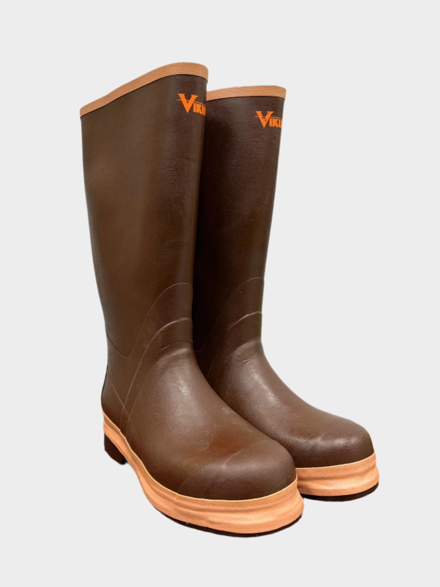 Brown mens rubber rain boots and tan seam on top and sole. Small bright orange Viking logo an inch below top edge. Chevron sole with slight heel.