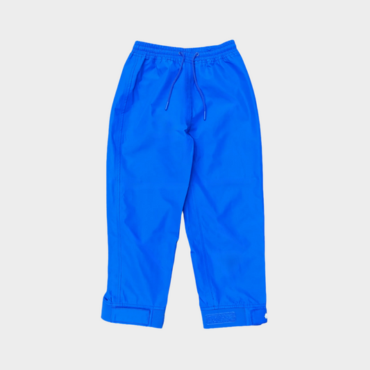 A pair of kids rain pants with an elastic waistband and drawstring. Ankles have a neoprene covered velcro adjustment. Shown in a bright mid blue