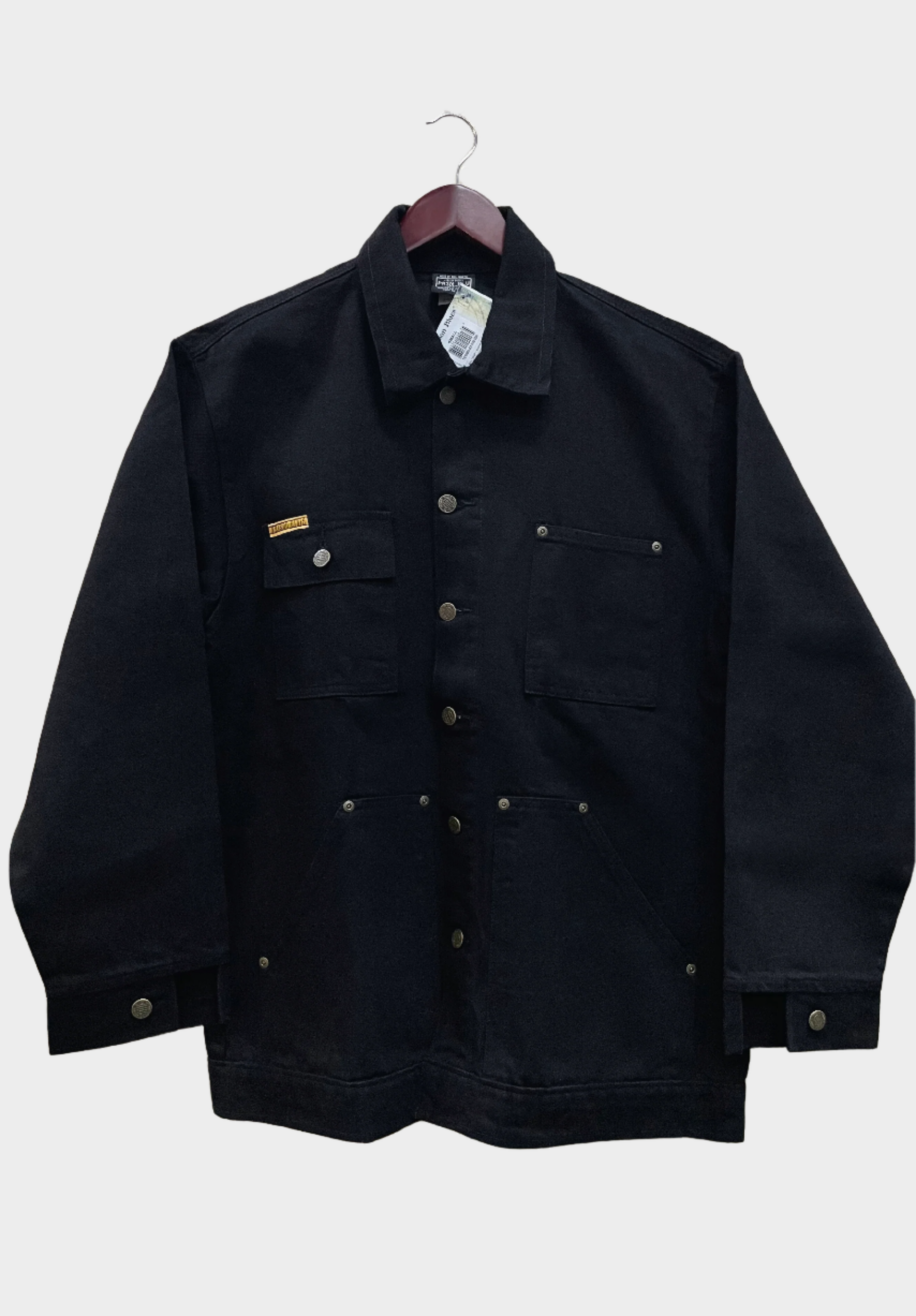 Collard yard coat with button down front. Button cuffs. 4 Pockets total, one pocket and one chest pocket on each side. Shown in black. Metal button details