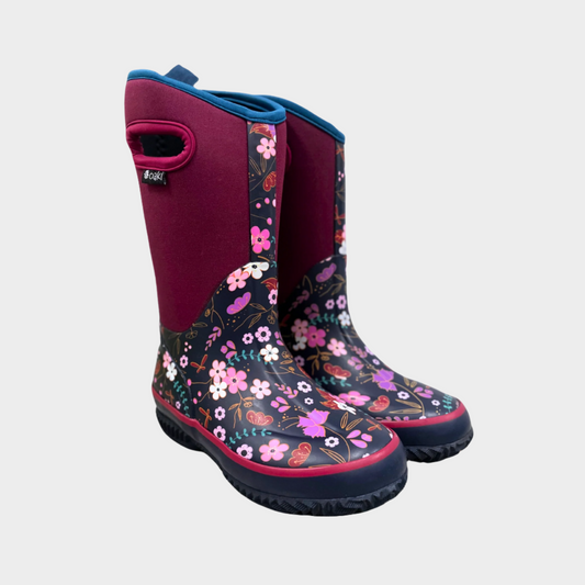 kids purple neoprene boots with rubber foot in purple floral and sole. Cutout handles