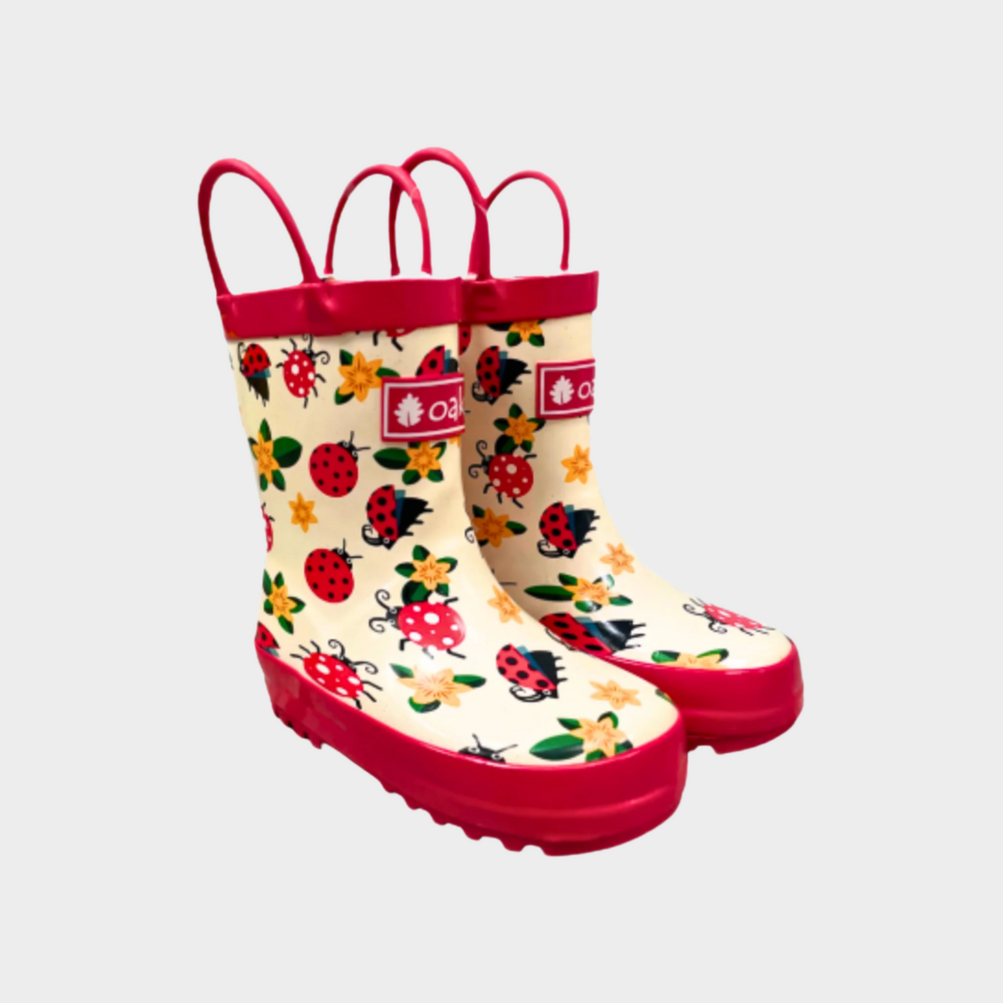 Kids rubber rain boots with ladybugs pattern rubber and oaki logo. Black tread and loop handles.