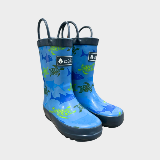 Kids rubber rain boots with blue sharks and green turtles rubber and oaki logo. Black tread and loop handles.